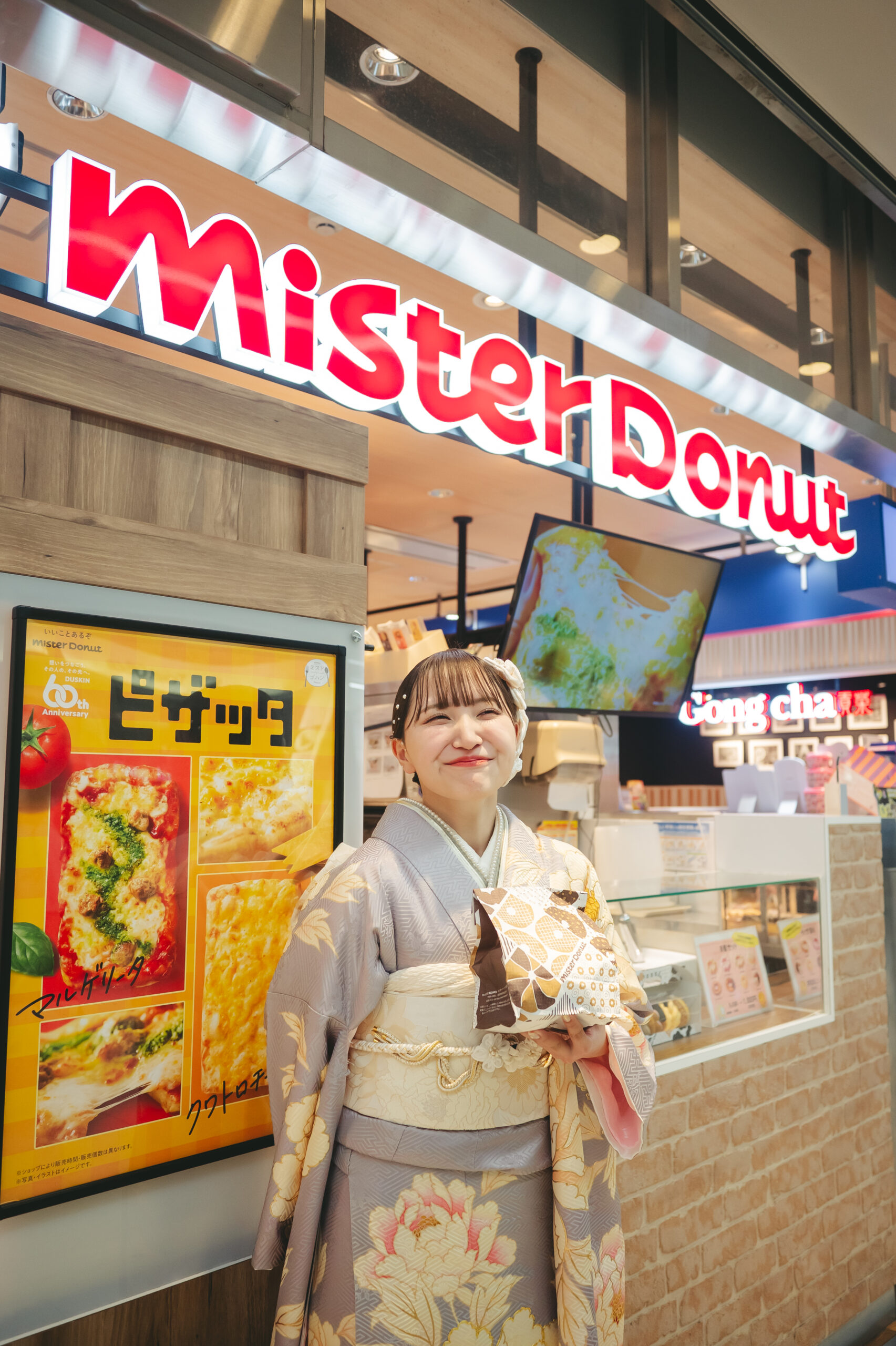成人式の振袖姿のままお気に入りのミスタードーナツの前でポーズをとるお洒落でポップな前撮りスナップ
