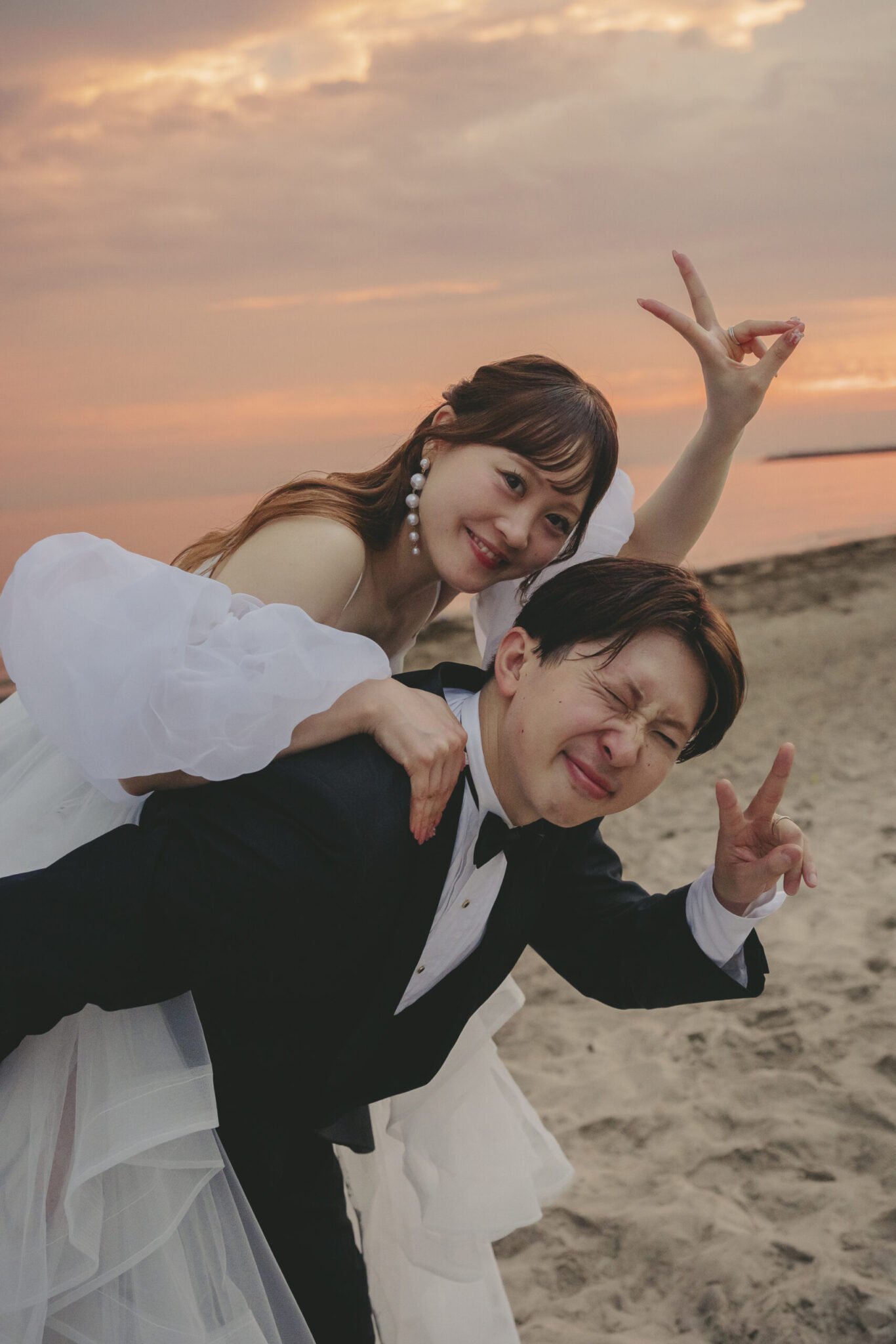 海に沈む夕日のマジックアワーの光に包まれた新郎新婦の幻想的な千葉ロケーション前撮り
