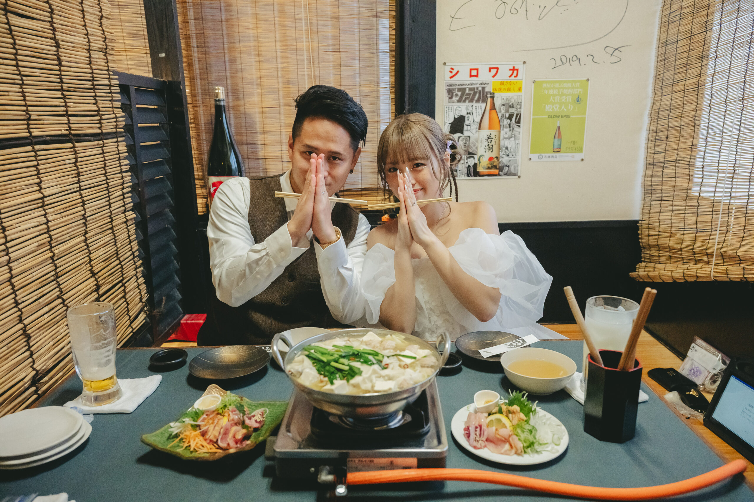 鹿児島の居酒屋心菜坊でいただきますのポーズで前撮りの二人